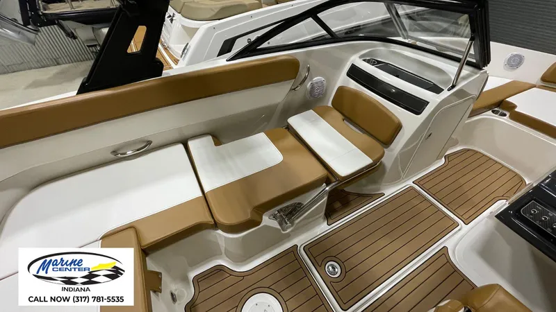 Slide: The Image of 2019 Bayliner VR 5 boat interior with tan and white seating, wood-style flooring. - 8