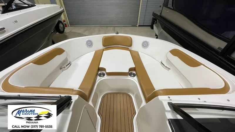 Slide: The Image of 2019 Bayliner VR 5 boat interior with tan and white seating, wood-style flooring. - 9