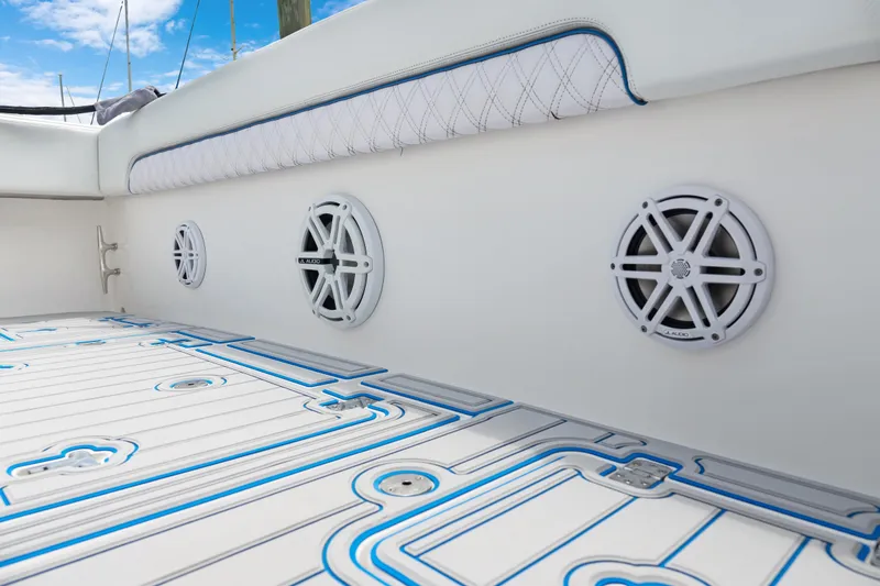 Slide: The Image of 2004 Intrepid 377 Walkaround boat interior with speakers and patterned flooring. - 12