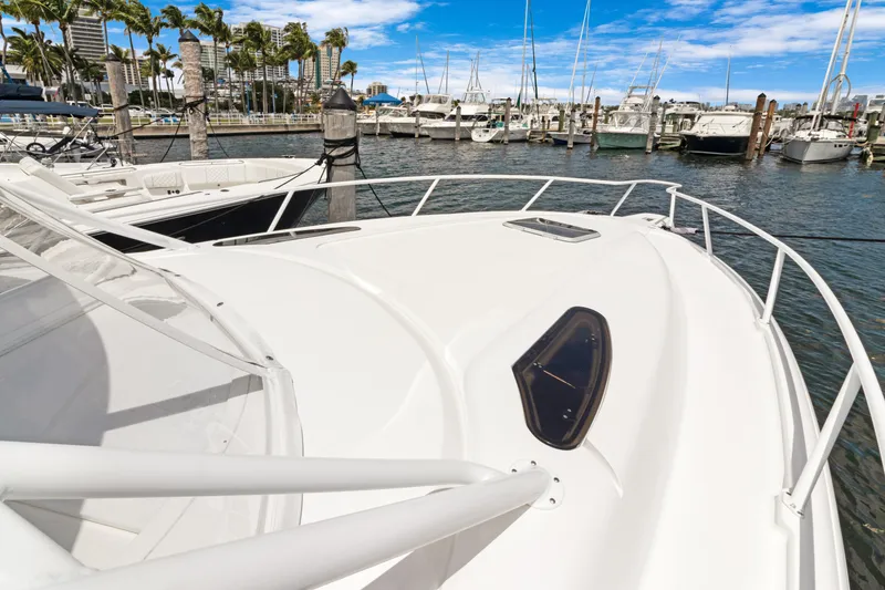 Slide: The Image of 2004 Intrepid 377 Walkaround boat docked in a marina with clear skies. - 21