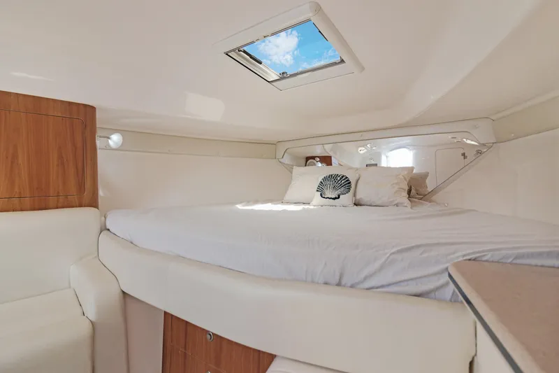 Slide: The Image of Luxurious cabin interior of 2004 Intrepid 377 Walkaround with skylight and cozy bedding. - 31