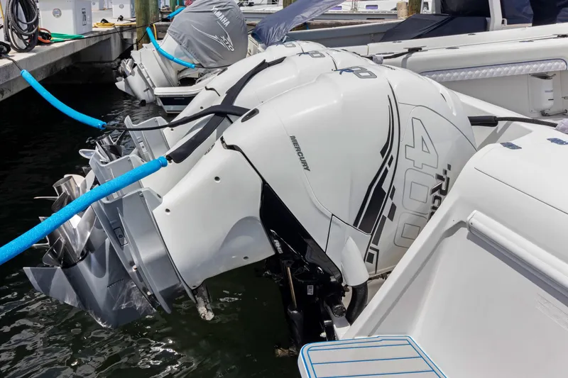 Slide: The Image of 2004 Intrepid 377 Walkaround with powerful outboard engines docked at marina. - 51