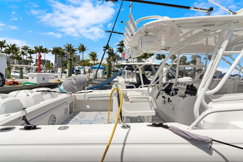 Slide: The Image of 2004 Intrepid 377 Walkaround boat docked at marina under clear blue sky. - 52