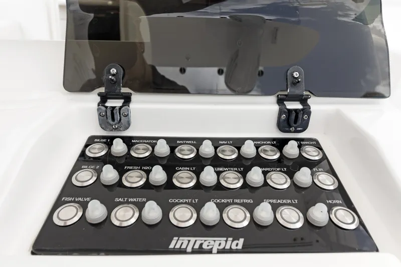 Slide: The Image of Control panel of a 2004 Intrepid 377 Walkaround boat with labeled switches. - 9