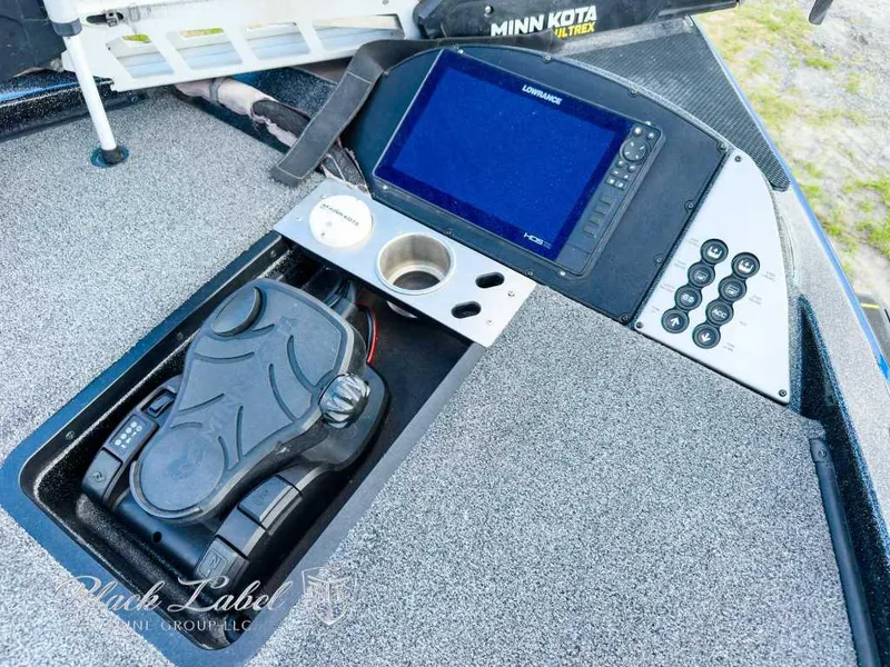 Slide: The Image of 2023 Caymas Bass CX 20 Pro interior with gray and blue seating, cup holders, and textured flooring. - 10