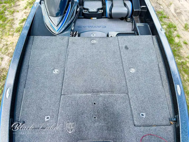Slide: The Image of 2023 Caymas Bass CX 20 Pro interior with gray and blue seating, storage compartment, and cup holders. - 11