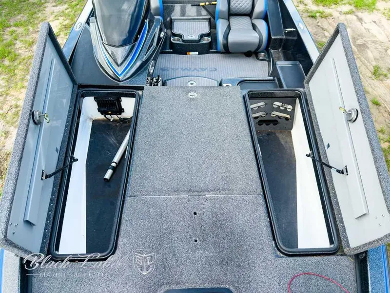 Slide: The Image of 2023 Caymas Bass CX 20 Pro boat interior with gray and blue seating, carpeted deck. - 12