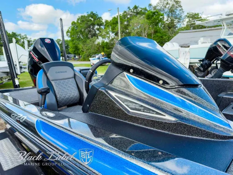 Slide: The Image of 2023 Caymas Bass CX 20 Pro boat on trailer, parked on grass. - 3