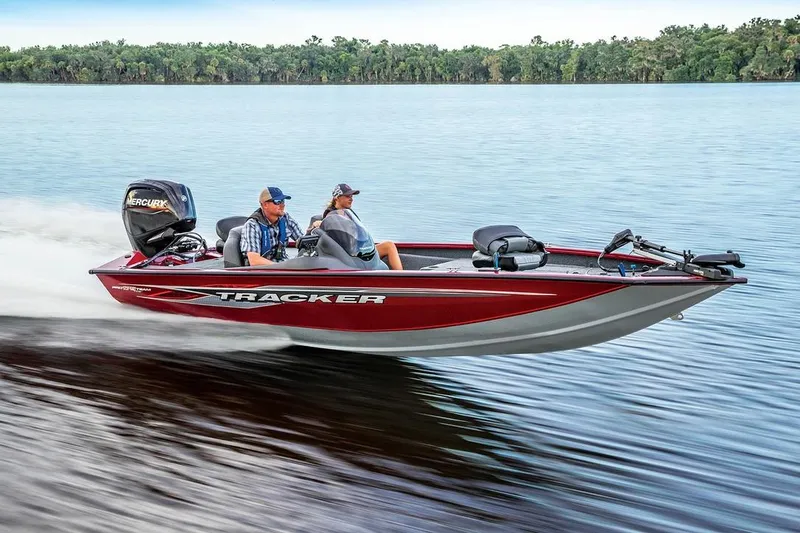 Slide: The Image of 2025 Tracker Pro Team 175 boat speeding on a lake with two passengers. - 13
