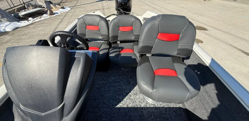 Slide: The Image of 2025 Tracker Pro Team 175 boat interior with gray and red seating. - 14
