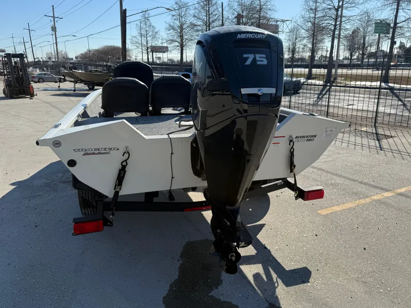 Slide: The Image of 2025 Tracker Pro Team 175 boat with Mercury 75 engine, parked outdoors. - 3