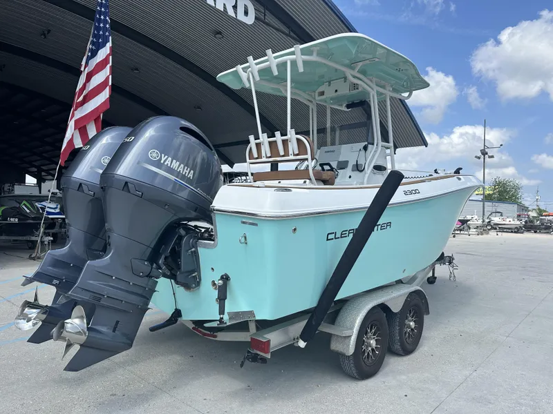 Slide: The Image of 2019 Clearwater 2300 Center Console boat with dual Yamaha engines on a trailer. - 1