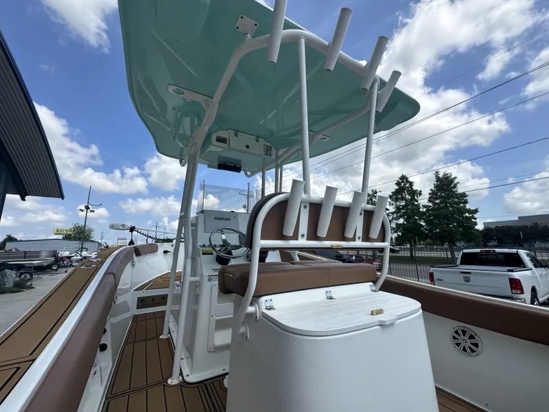 Slide: The Image of 2019 Clearwater 2300 Center Console boat with rod holders and seating, under a blue sky. - 4