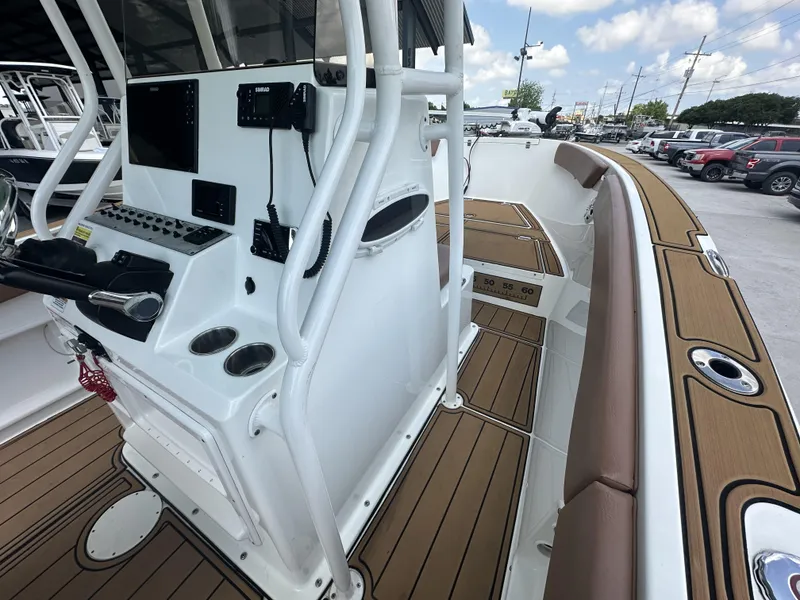 Slide: The Image of 2019 Clearwater 2300 Center Console boat interior with modern controls and wood-style flooring. - 6