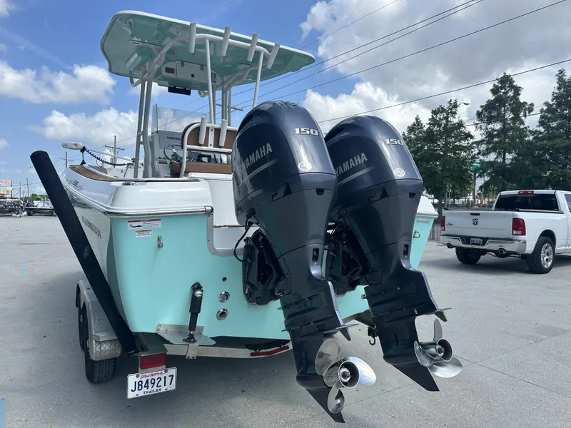 Slide: The Image of 2019 Clearwater 2300 boat with dual Yamaha 150 engines on a trailer. - 19