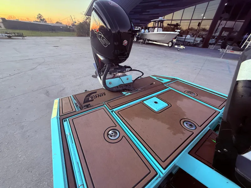 Slide: The Image of Custom Uncle J 19 Bay Center Console Aluminum boat, 2022 model, with outboard motor in a marina. - 11