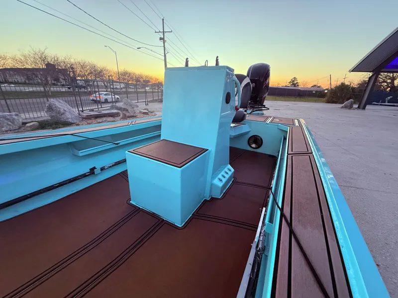 Slide: The Image of 2022 Custom Uncle J 19 Bay Center Console Aluminum boat at sunset, featuring sleek design. - 15