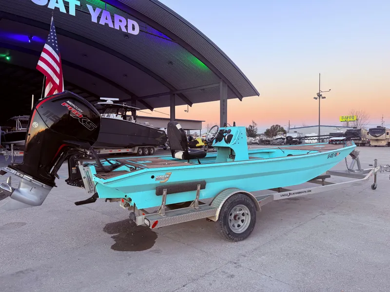 Slide: The Image of 2022 Custom Uncle J 19 Bay Center Console Aluminum boat on trailer at sunset. - 2