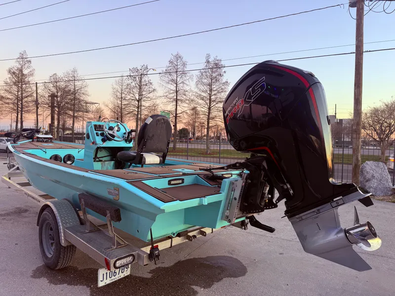 Slide: The Image of Custom Uncle J 19 Bay Center Console Aluminum boat, 2022 model, on trailer at sunset. - 5