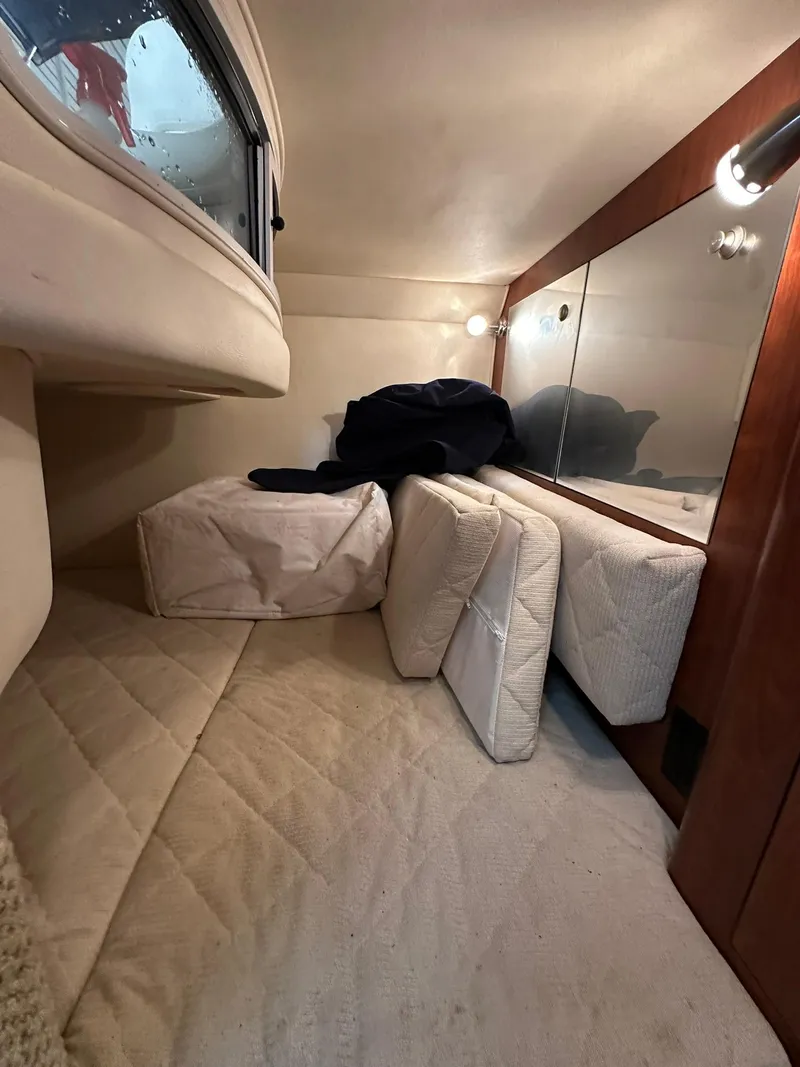 Slide: The Image of Interior cabin of 2007 Sea Ray 280 Sundancer with cushions and wood paneling. - 11