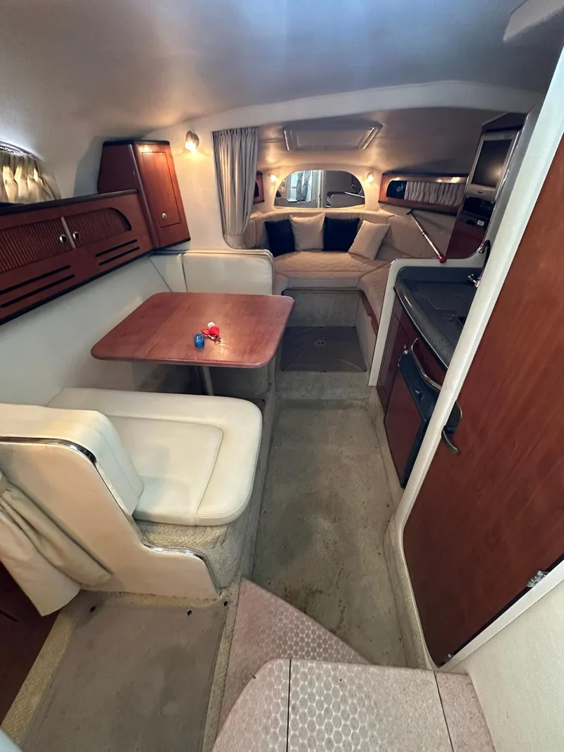 Slide: The Image of Interior of 2007 Sea Ray 280 Sundancer with dining area and cozy seating. - 13