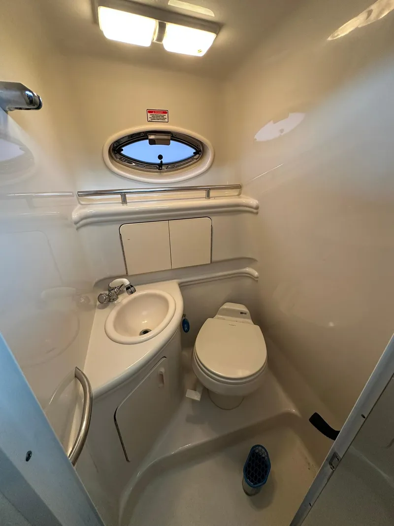 Slide: The Image of Compact bathroom in 2007 Sea Ray 280 Sundancer boat with sink and toilet. - 15