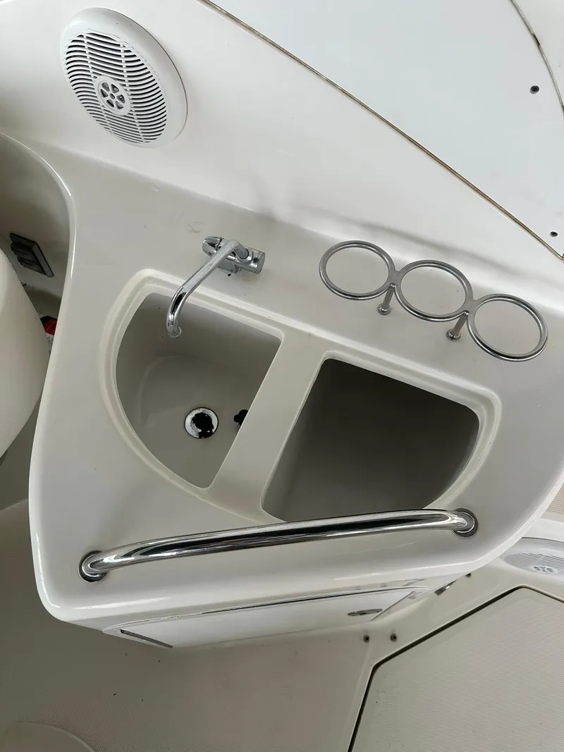 Slide: The Image of 2007 Sea Ray 280 Sundancer boat sink and cup holders in white interior. - 16