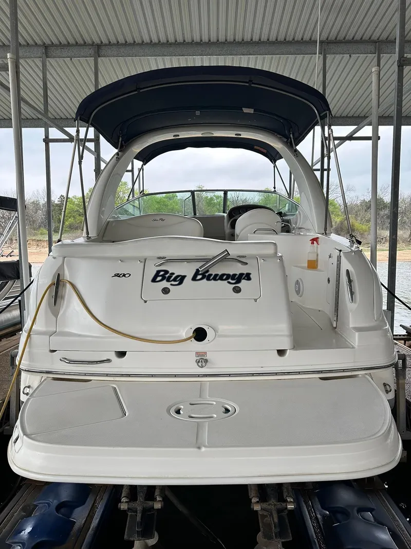 Slide: The Image of 2007 Sea Ray 280 Sundancer boat docked, rear view with "Big Buoys" name. - 17