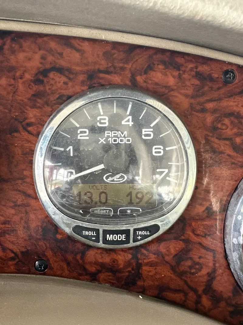 Slide: The Image of Close-up of 2007 Sea Ray 280 Sundancer RPM gauge on wood grain dashboard. - 24