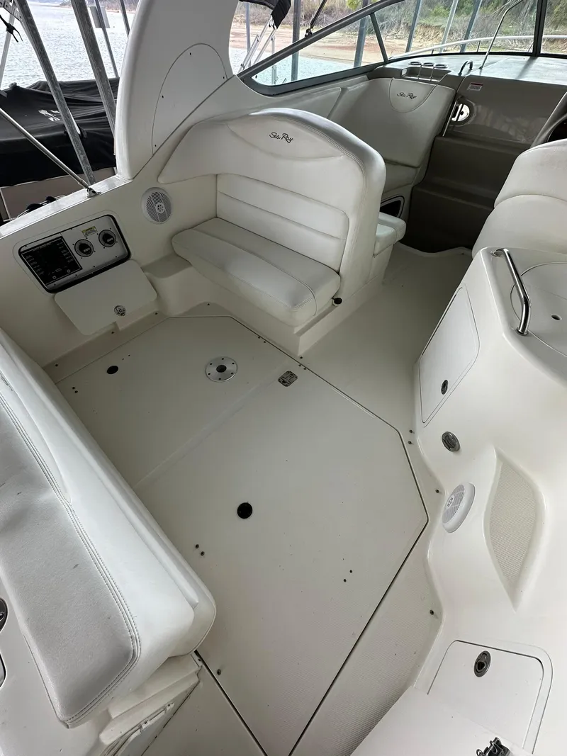 Slide: The Image of 2007 Sea Ray 280 Sundancer boat interior with white seating and control panel. - 3