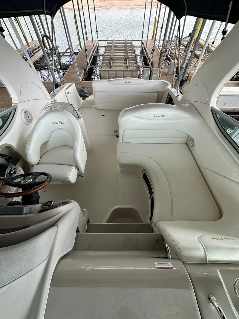 Slide: The Image of 2007 Sea Ray 280 Sundancer boat interior with white seating and steering wheel. - 5