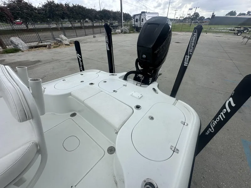 Slide: The Image of 2012 Yellowfin 24 Bay boat with motor and Power-Pole anchors in a parking area. - 11