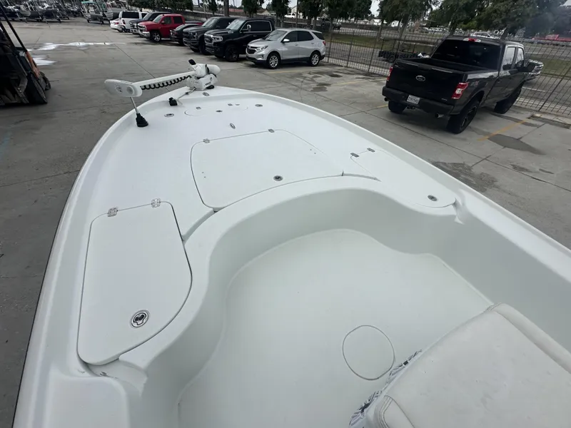 Slide: The Image of 2012 Yellowfin 24 Bay boat deck in parking lot, surrounded by vehicles. - 12