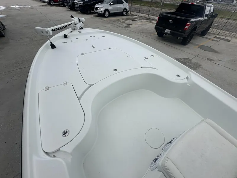 Slide: The Image of 2012 Yellowfin 24 Bay boat deck with storage compartments and trolling motor. - 6