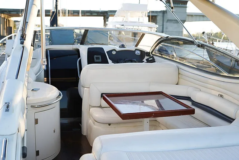 Slide: The Image of Sunseeker Superhawk 48 Mk II 2000 yacht interior with white seating and wooden table. - 10