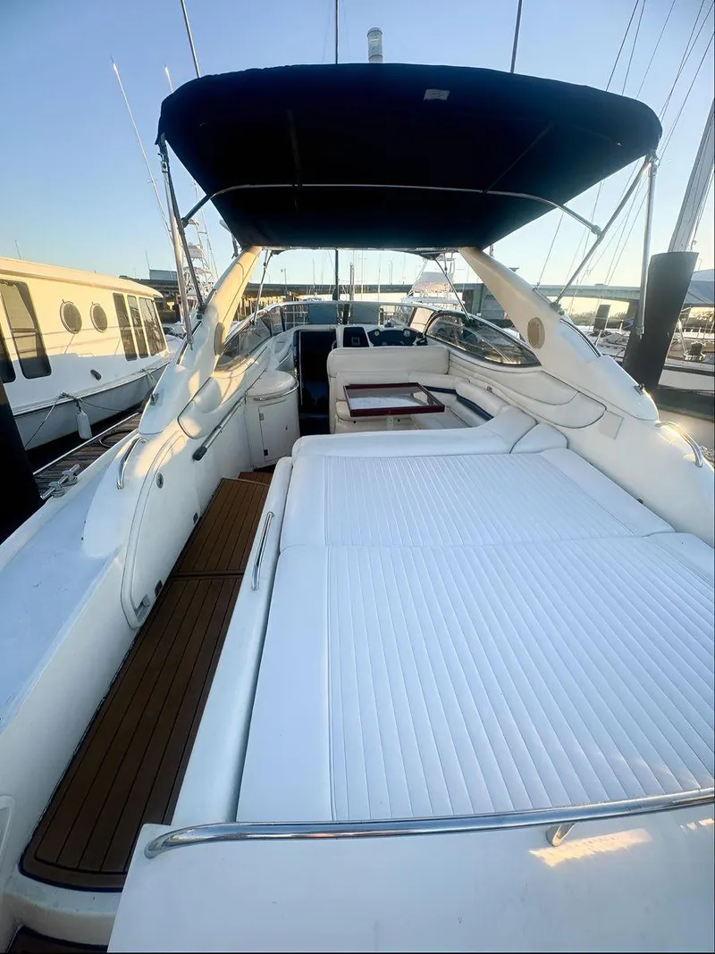 Slide: The Image of Sunseeker Superhawk 48 Mk II 2000 yacht with spacious deck and seating area, docked at marina. - 14