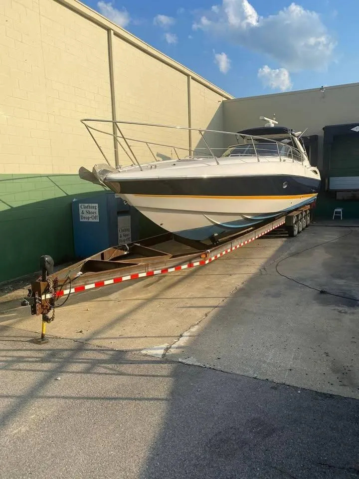 Slide: The Image of Sunseeker Superhawk 48 Mk II 2000 on trailer, parked outdoors under clear sky. - 18
