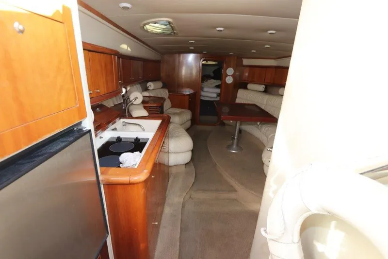 Slide: The Image of Interior of 2000 Sunseeker Superhawk 48 Mk II yacht with kitchen and seating area. - 19