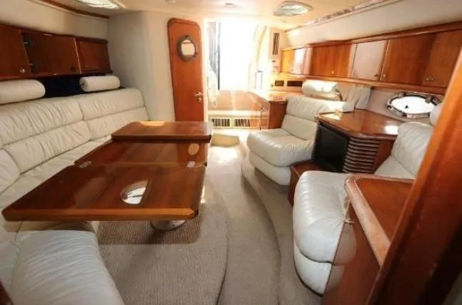 Slide: The Image of Luxurious interior of 2000 Sunseeker Superhawk 48 Mk II yacht with elegant wood and leather furnishings. - 8