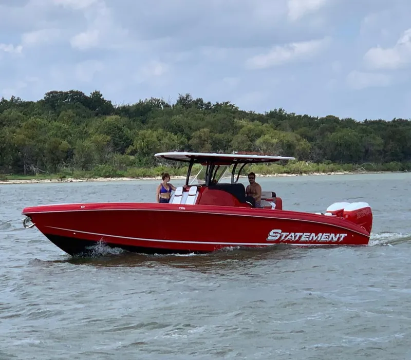 Slide: The Image of Red 2019 Statement 350 Open boat cruising on a lake with passengers onboard. - 3