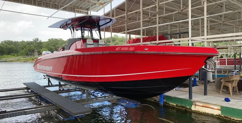 Slide: The Image of Red 2019 Statement 350 Open boat docked at marina, side view. - 9
