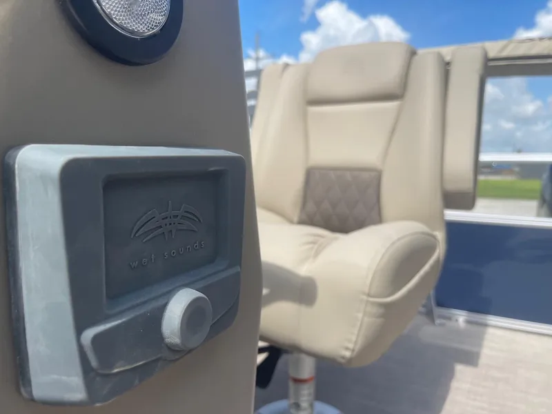 Slide: The Image of 2025 Sun Tracker Bass Buggy 16 XL interior with beige seating and audio control. - 14