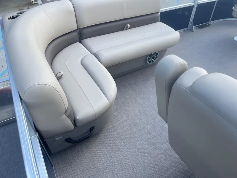 Slide: The Image of 2025 Sun Tracker Bass Buggy 16 XL interior with beige seating and carpeted floor. - 18