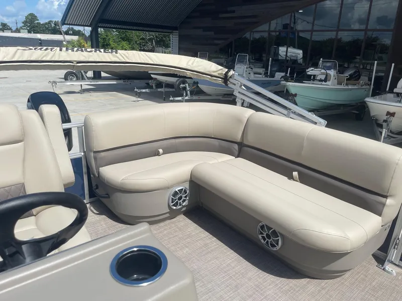 Slide: The Image of 2025 Sun Tracker Bass Buggy 16 XL pontoon boat with beige seating and cup holder. - 15