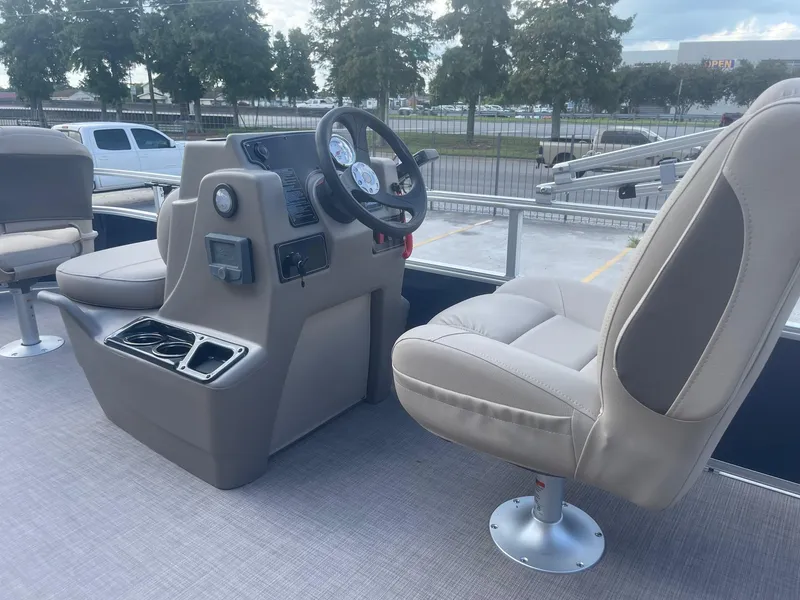Slide: The Image of 2025 Sun Tracker Bass Buggy 16 XL boat interior with steering console and seating. - 19