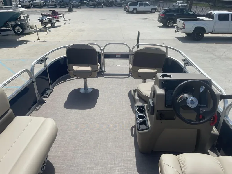 Slide: The Image of 2025 Sun Tracker Bass Buggy 16 XL pontoon boat interior with seating and steering console. - 9