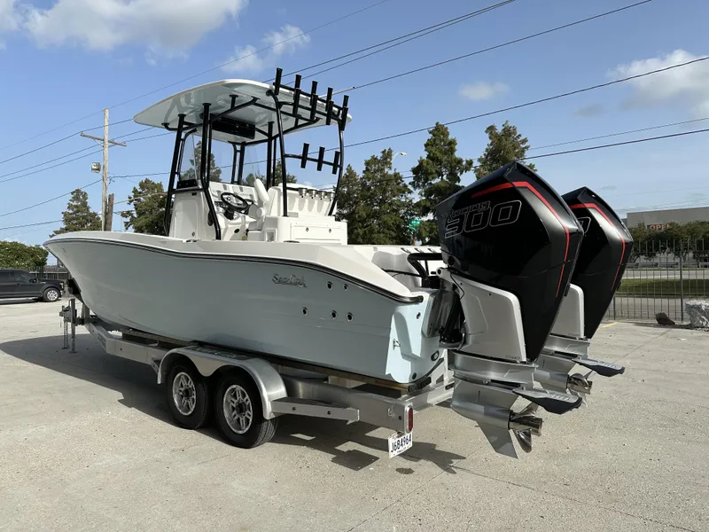 Slide: The Image of 2023 Sea Cat 262 Hybrid boat with twin Mercury 300Rs engines, parked on a trailer. - 5