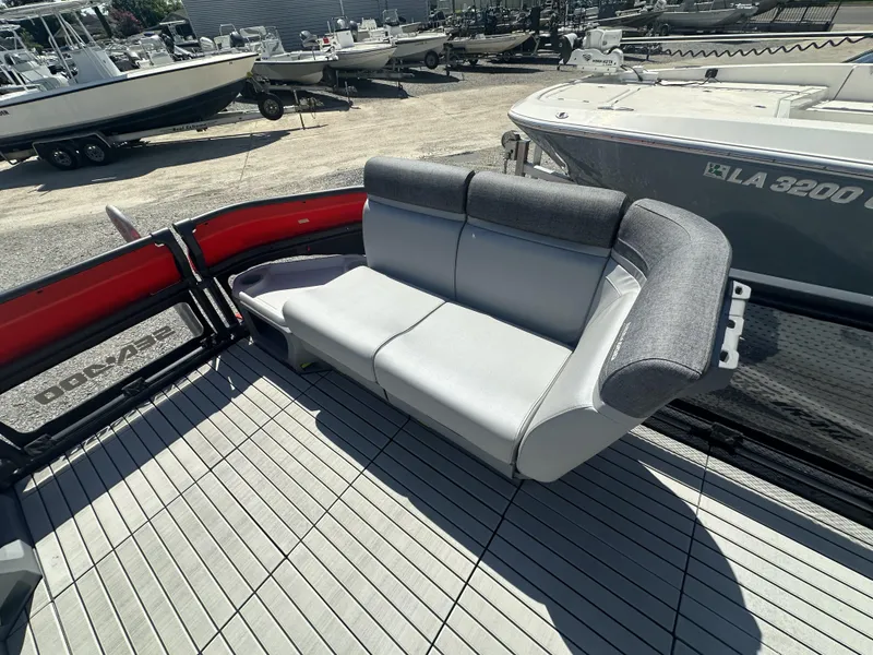 Slide: The Image of 2023 Sea-Doo Switch Cruise 21' boat interior with gray seating and red accents. - 11