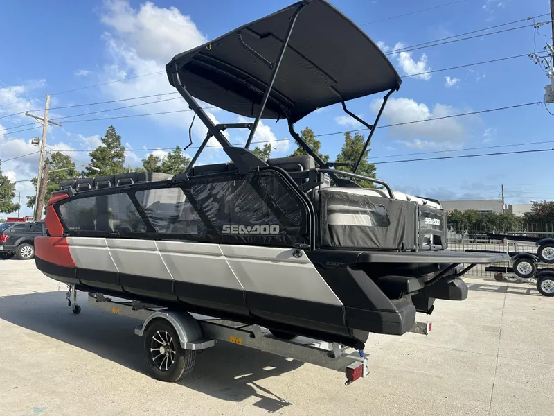 Slide: The Image of 2023 Sea-Doo Switch Cruise 21' boat with 230HP, parked on a trailer under a clear sky. - 13