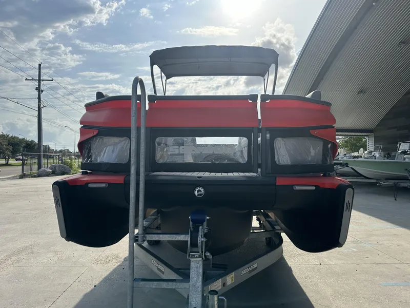 Slide: The Image of 2023 Sea-Doo Switch Cruise 21' pontoon boat on trailer, rear view, sunny day. - 5